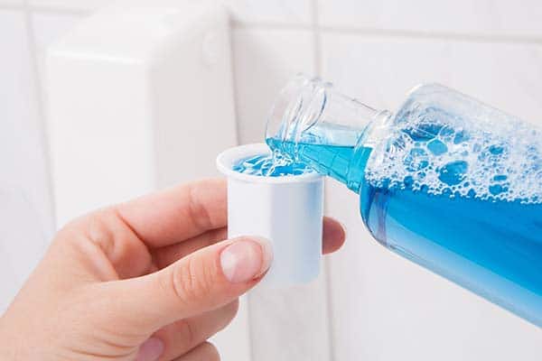 pouring mouthwash